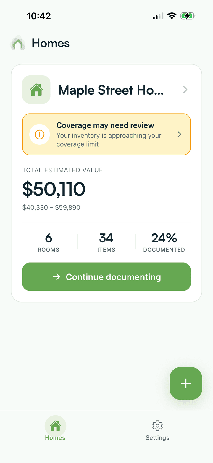 Hometric's home screen showing a home's total estimated value, room and item counts, and a coverage-review alert.
